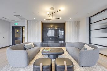 A modern living room with grey couches and a coffee table.